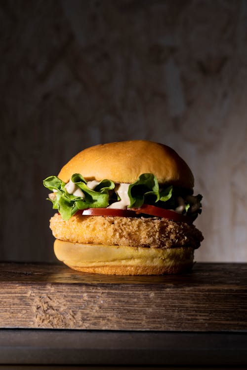 Close-Up Shot of a Delicious Hamburger on Wooden Surface