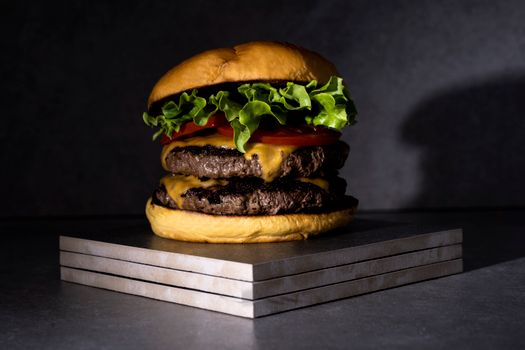 Mouthwatering double cheeseburger with lettuce, tomato, and cheese, perfect for food lovers.