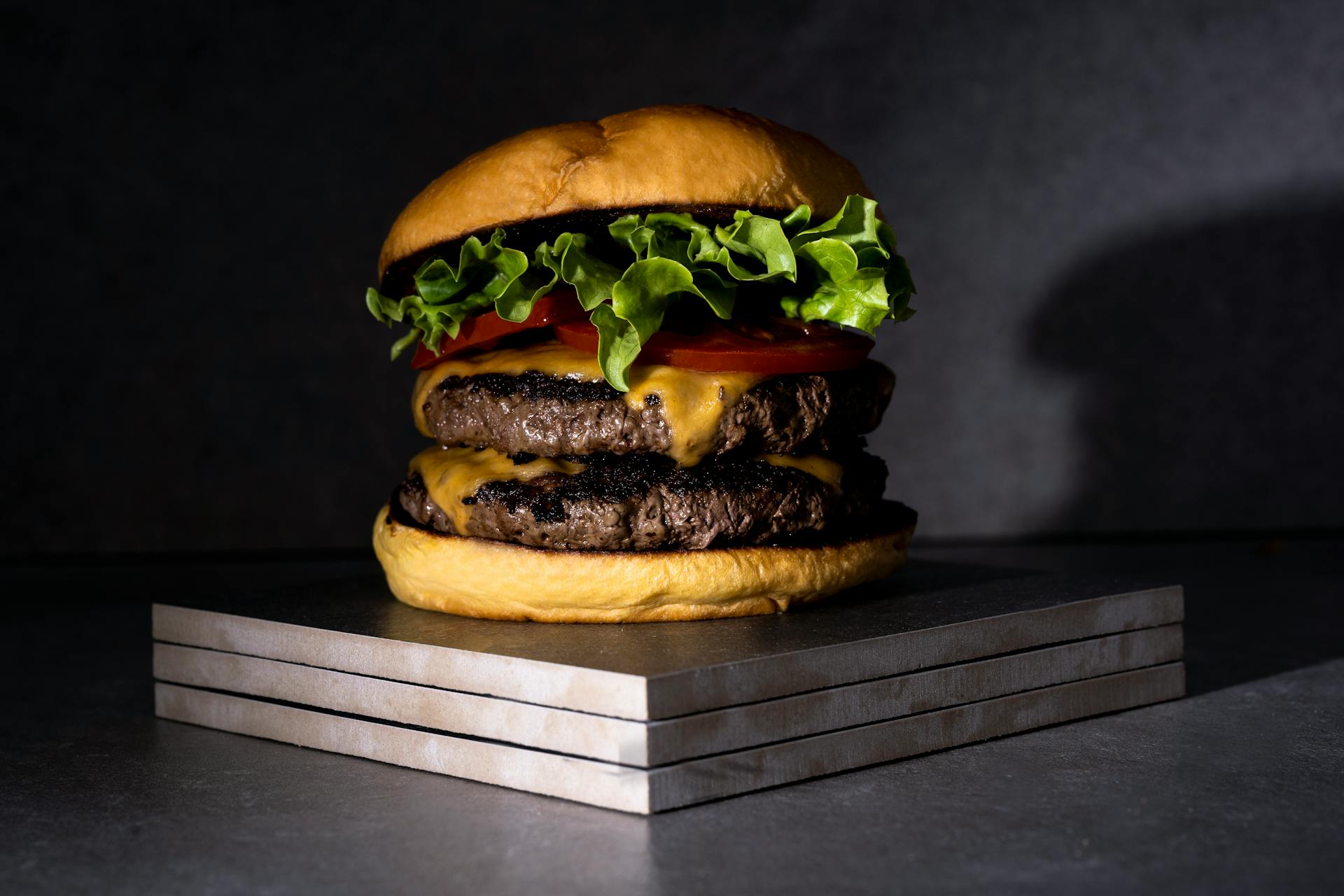 Mouthwatering double cheeseburger with lettuce, tomato, and cheese, perfect for food lovers.