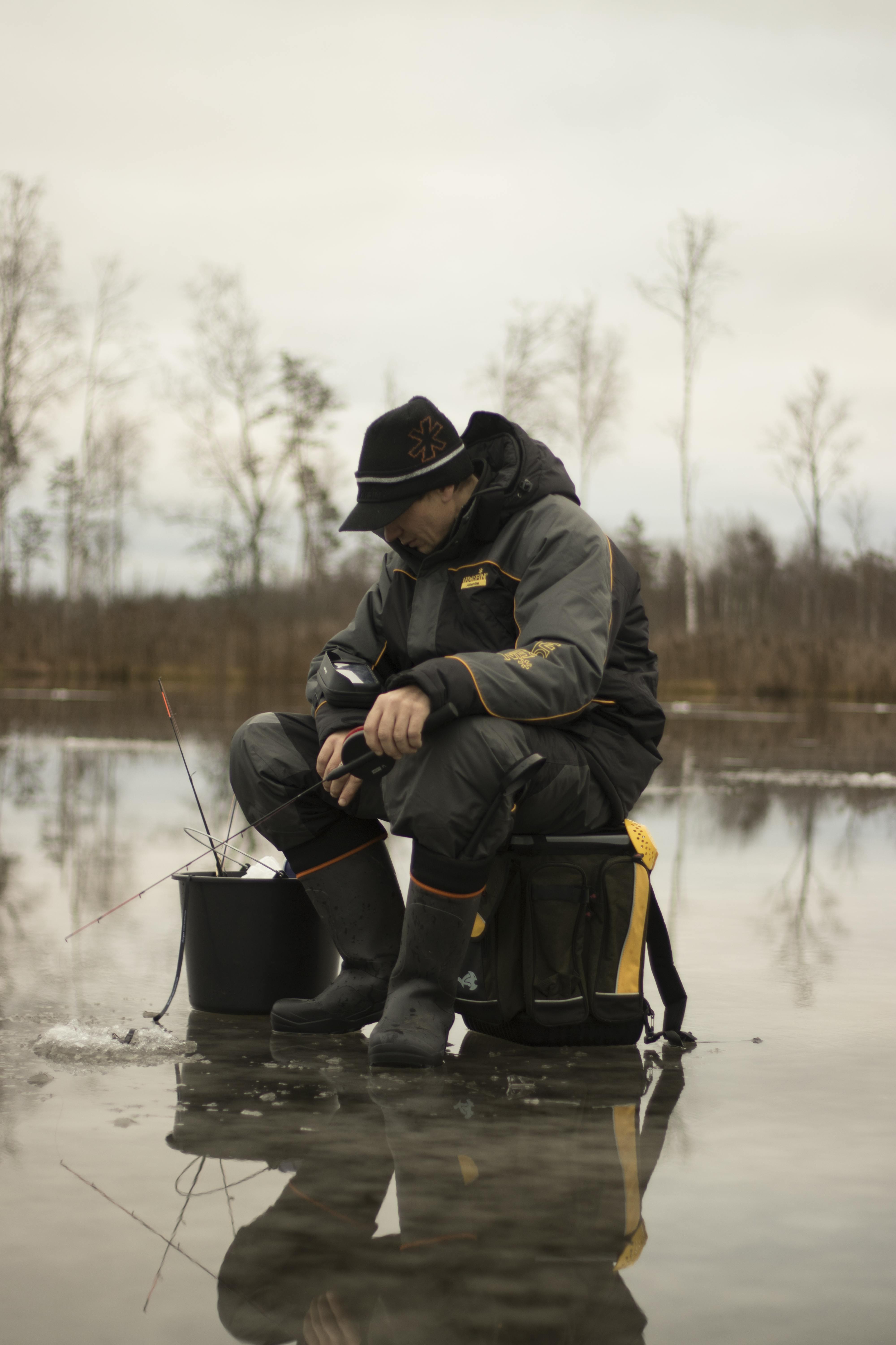 Man Sitting on Stool Ice Fishing · Free Stock Photo