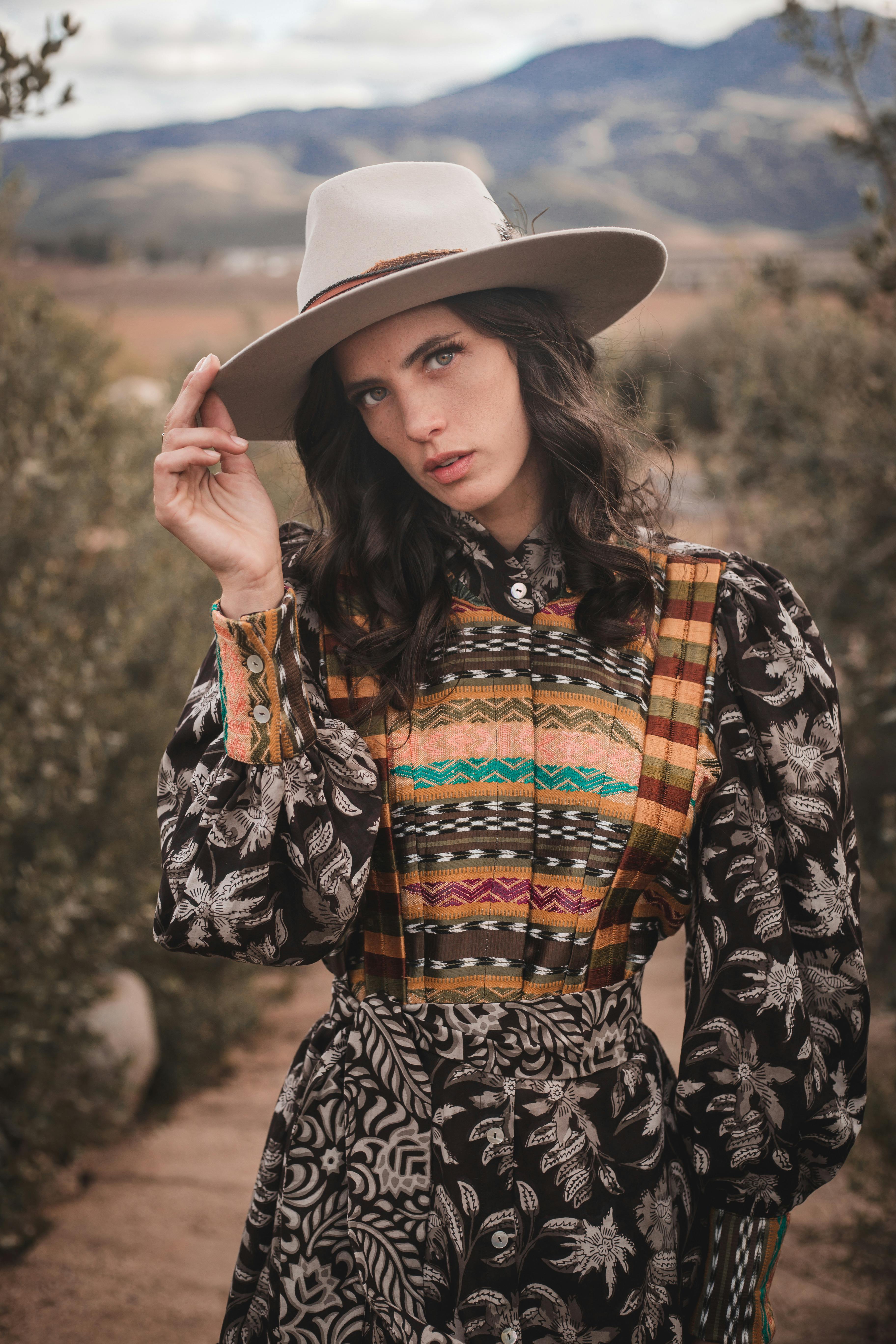 fashion shot of a woman in a patterned dress in semi desert