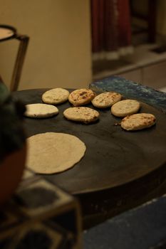 Homemade flatbreads baking on a traditional stove.