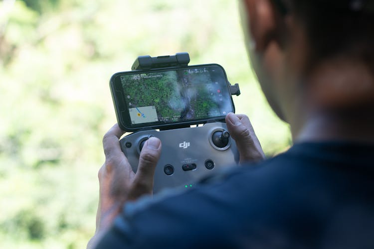 Person Holding Gray Drone Controller