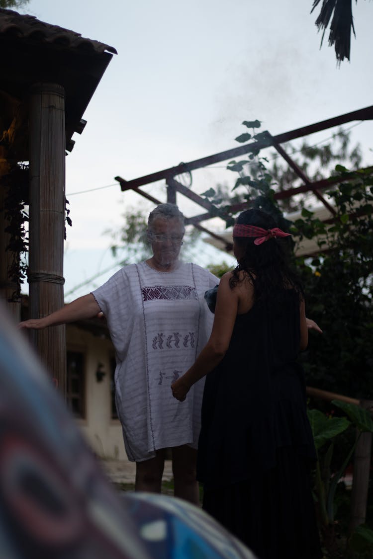 Two Women Standing In A Yard