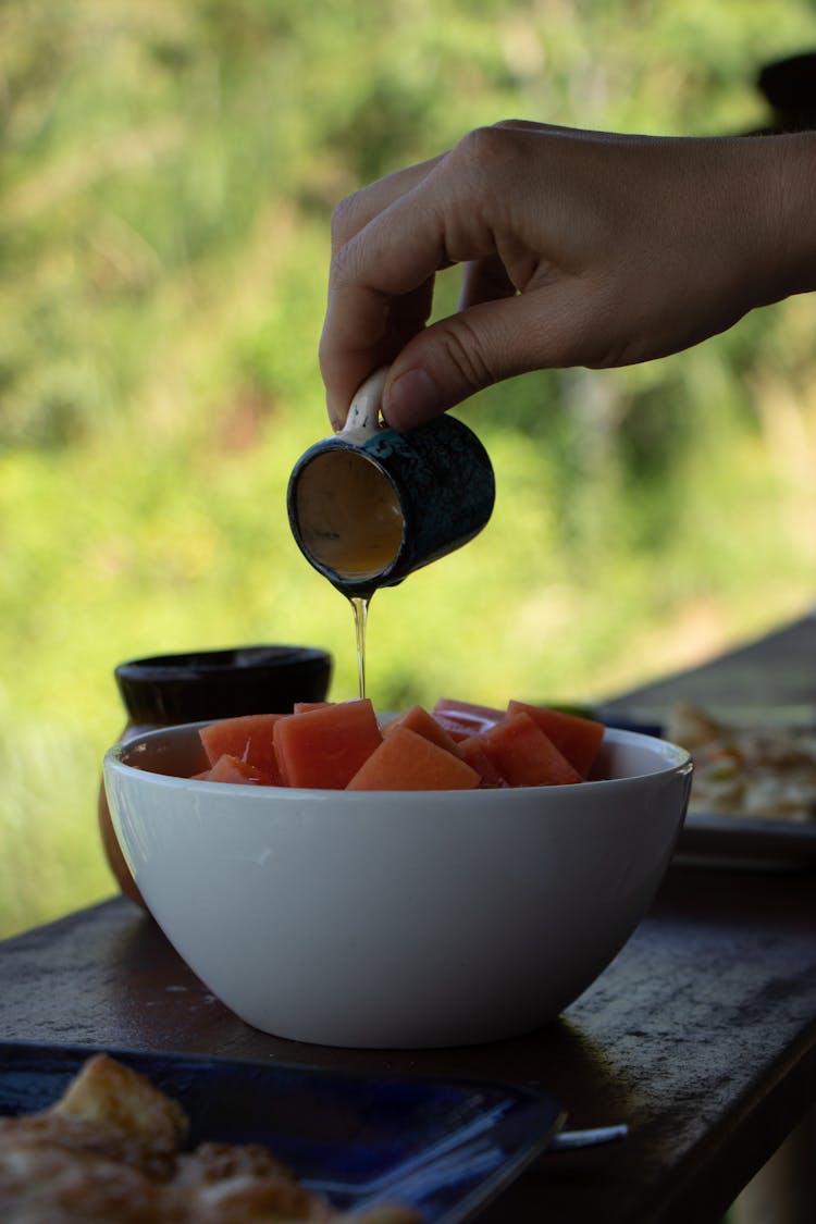 Person Cooking Fruit Salad In Nature