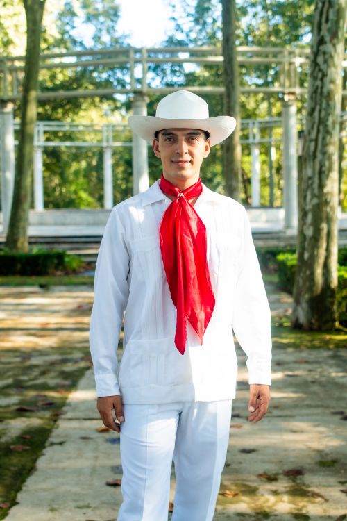 Free Portrait of a man in vibrant traditional Latin attire with hat, standing outdoors. Stock Photo