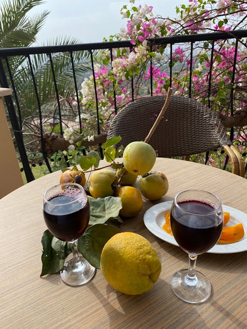 Glasses of Wine on a Table with Fruits