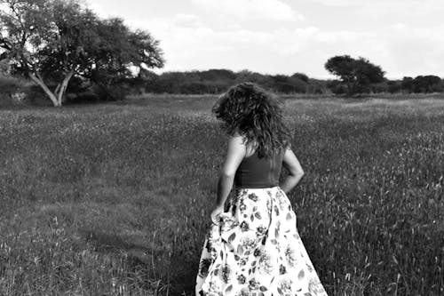 Grayscale Photo of a Woman in a Field