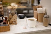 Cup of Coffee Standing on Counter of Cafeteria