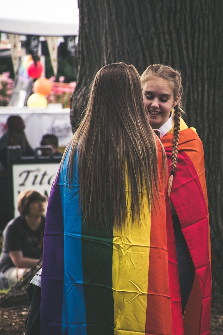 Girls With Colorful Flags At Outdoor Festival