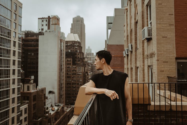 Man On A Balcony Overlooking The City