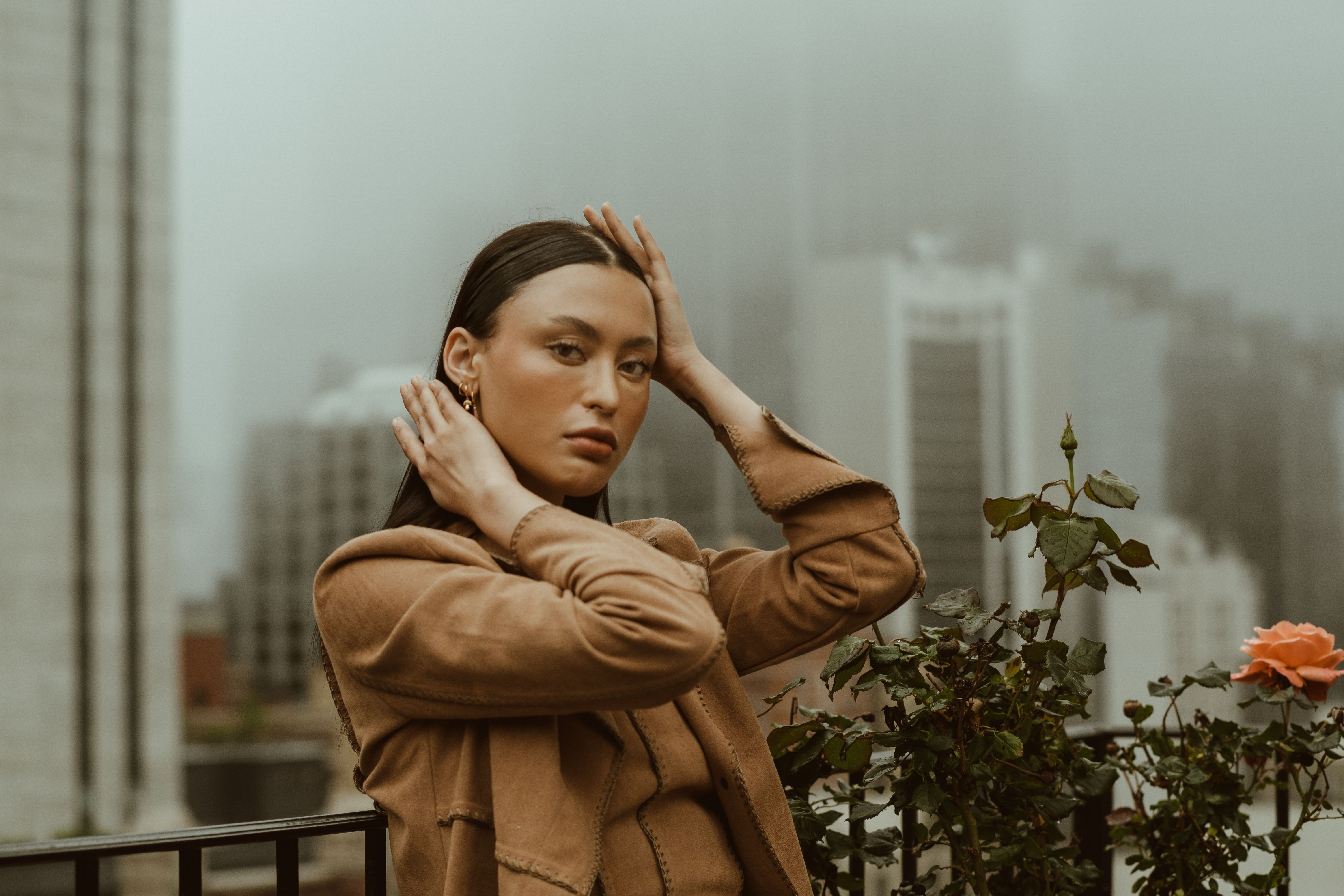 A Woman Posing with Her Hands on Her Head · Free Stock Photo
