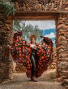 Woman in Artistic Costume Standing in Pose in Aztec Gate