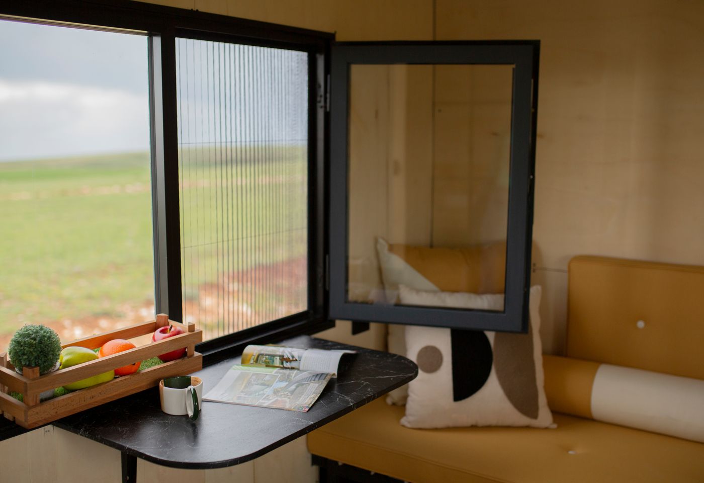 Compact dining area beside a tiny house window