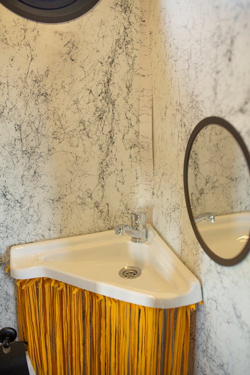 A White Sink with Stainless Faucet