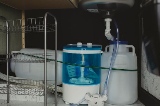 图片显示正在检查洗碗机排水管连接处是否有漏水