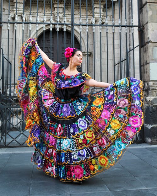 Free A Woman Wearing Colorful Dress While Dancing  Stock Photo