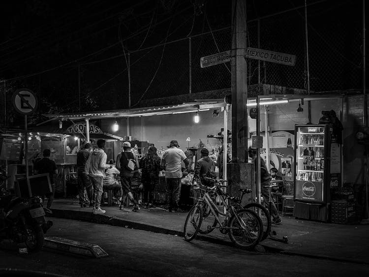 Black And White Photo Of People Drinking In Outdoor Pub