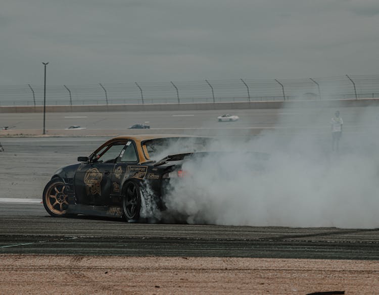 Black Car Drifting On A Race Track