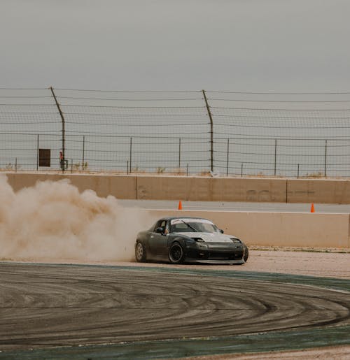 Black Race Car Drifting on Race Track