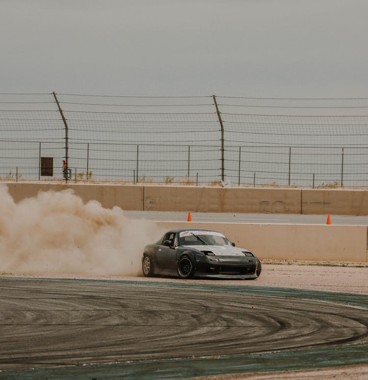 Black Race Car Drifting On Race Track