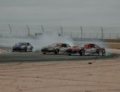 Black and Red Race Car on Brown Field