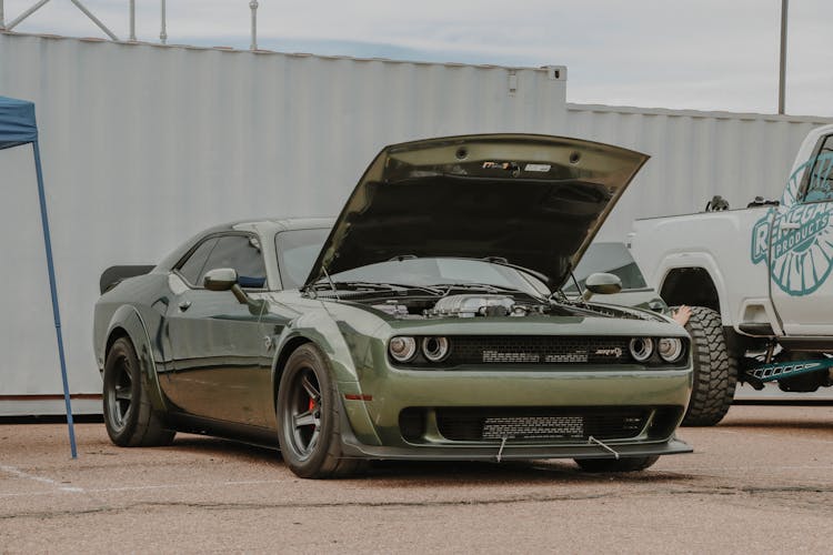 A Parked Dodge Challenger With An Open Hood