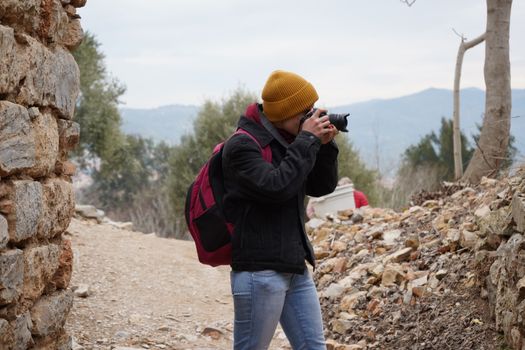 An outdoor photographer capturing shots among ancient ruins in İzmir, Turkey.
