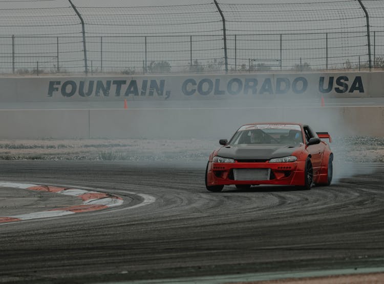 Red Car Drifting On Race Track