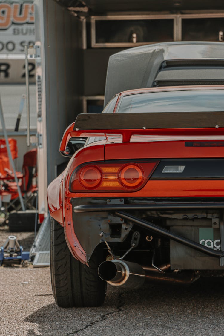 Red Racecar Parked At A Garage