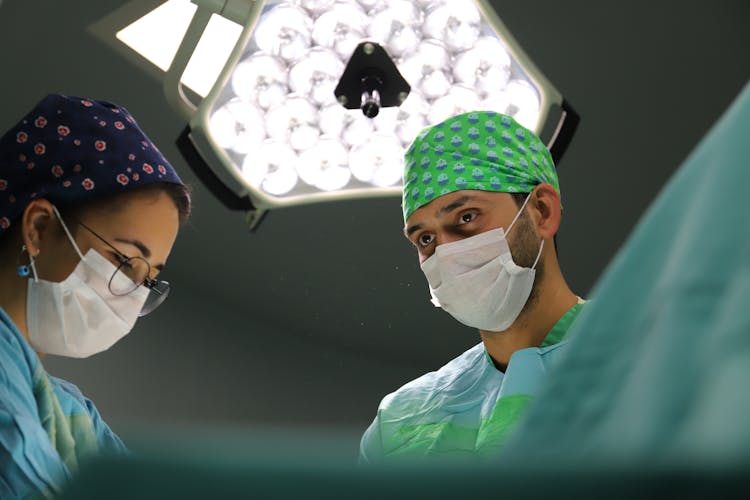 People Wearing Facemask While In The Operating Room