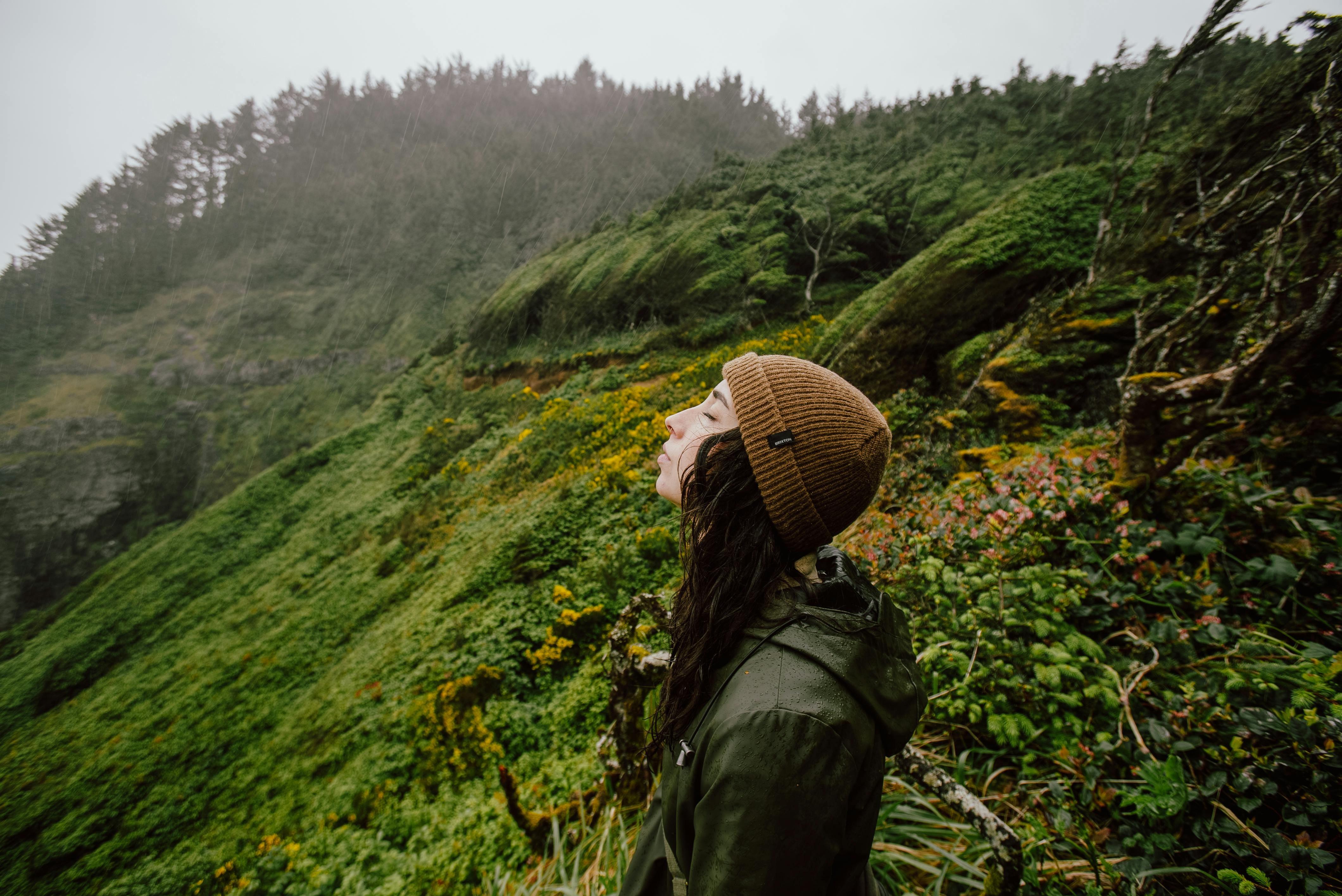 Woman enjoying a peaceful hike in the lush greenery of Oregon.