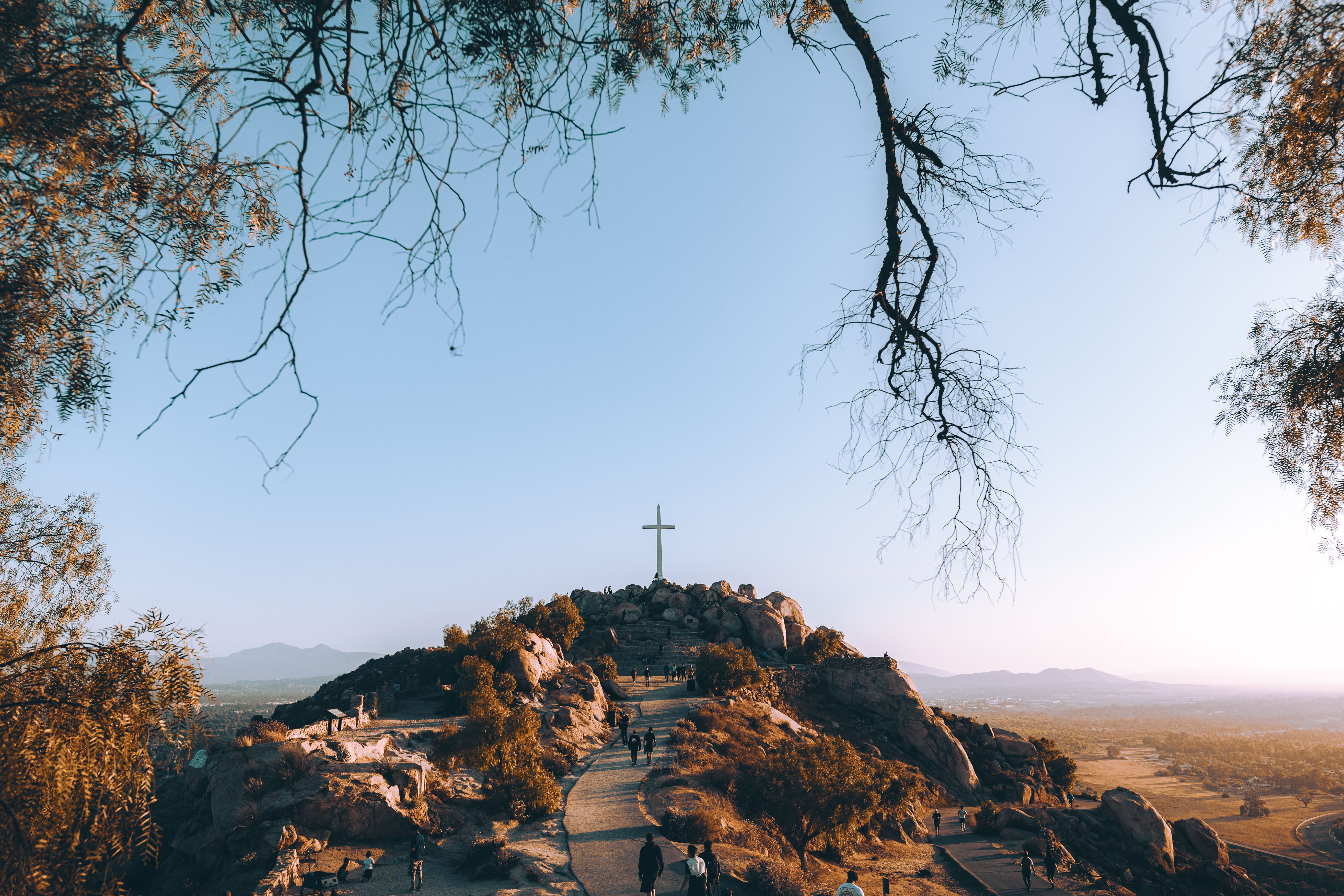 pilgrim walking towards light cross