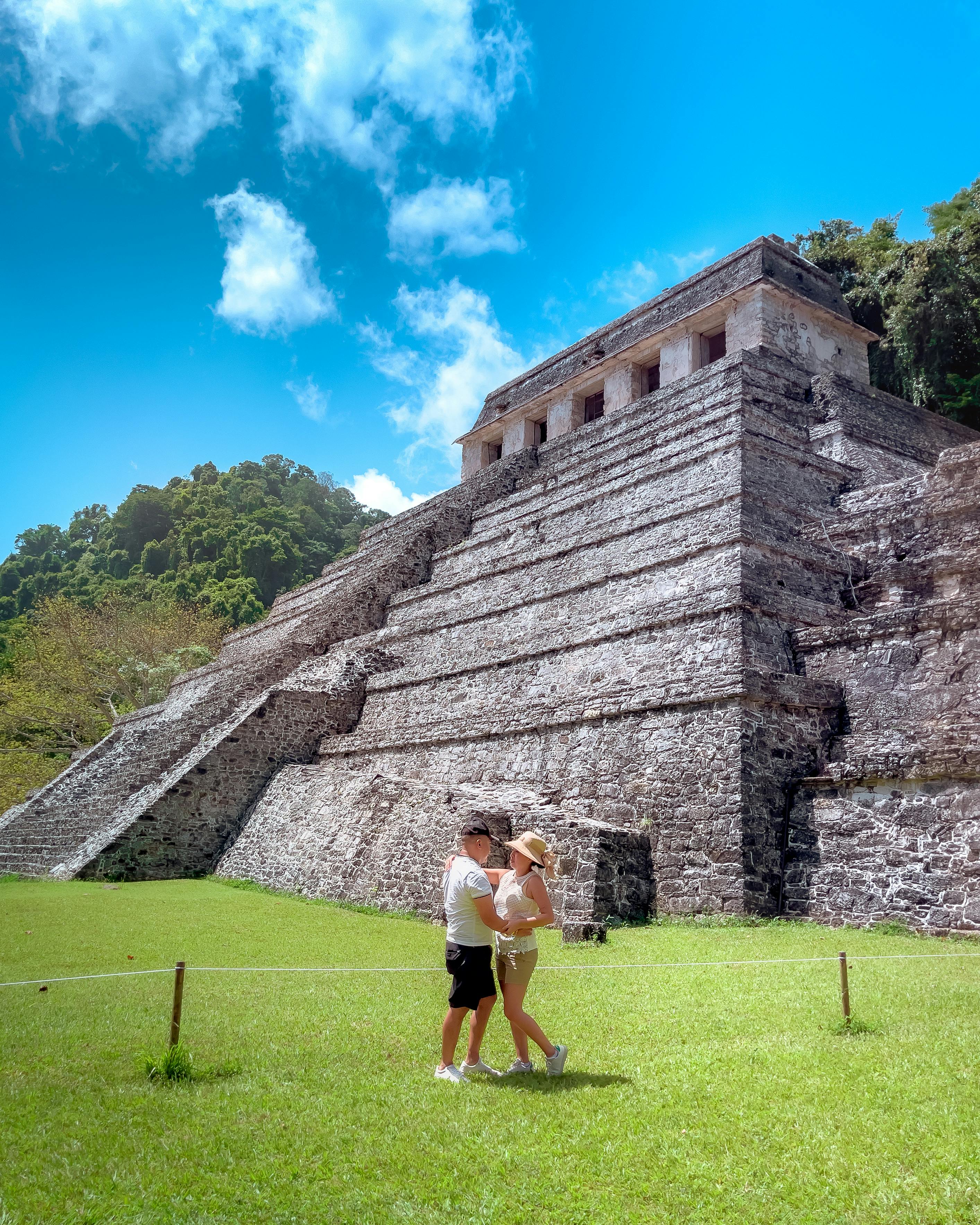couple in front of temple of the inscriptions chiapas mexico