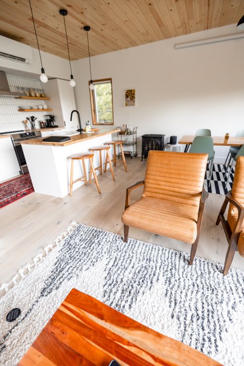 Free Spacious modern kitchen and living area with rustic elements and natural light. Stock Photo