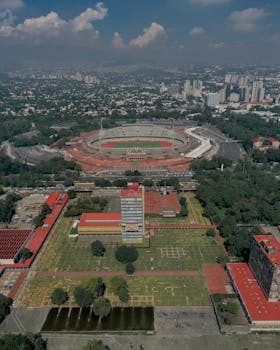 Aerial cityscape of the Estadio Olímpico Universitario, Mexico City, showcasing urban and stadium features.