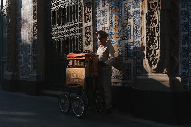 Organillero Playing On Street Organ 