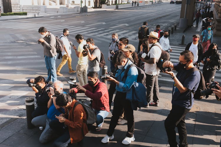 Group Of Photographers Making Photos With Professional Cameras