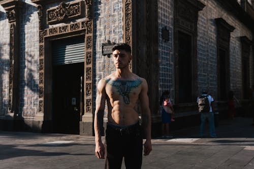 Young Man with Tattoos on Naked Torso