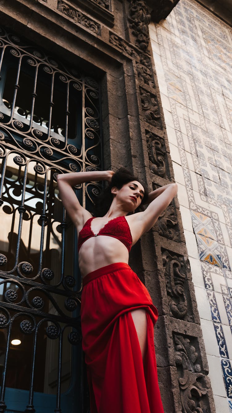 Woman In Red Skirt Posing Near Building