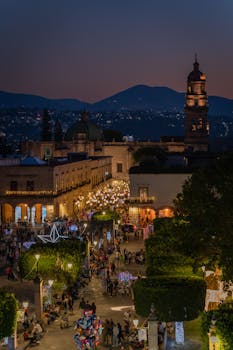 A bustling night market illuminated in a historic cityscape, showcasing architecture and cultural vibrancy.