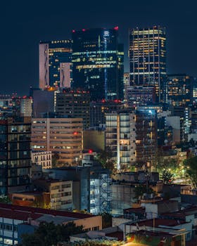 A stunning view of a city's illuminated skyline at night showcasing modern architecture.