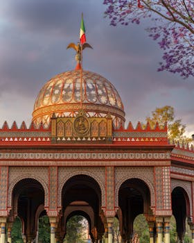 Beautiful Neo-Mudéjar architecture of Morisco Kiosk in Mexico City with Mexican flag at sunset.