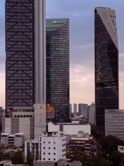 Free Modern skyscrapers tower over Mexico City at dusk, showcasing urban architecture. Stock Photo