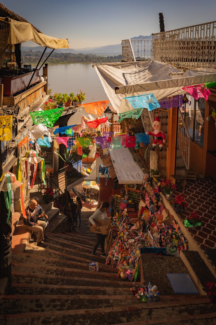 People Shopping For Souvenirs In Stalls Along A Staircase