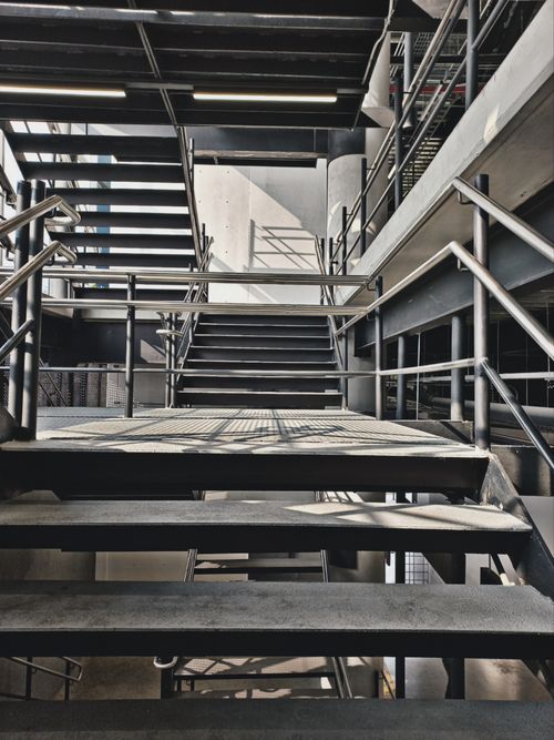 Free A modern metal staircase in an industrial-style urban building with natural lighting. Stock Photo