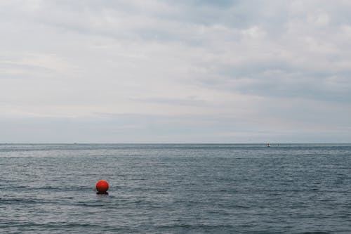 Red Buoy Floating on Body of Water