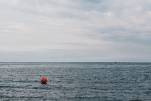 Red Buoy Floating on Body of Water