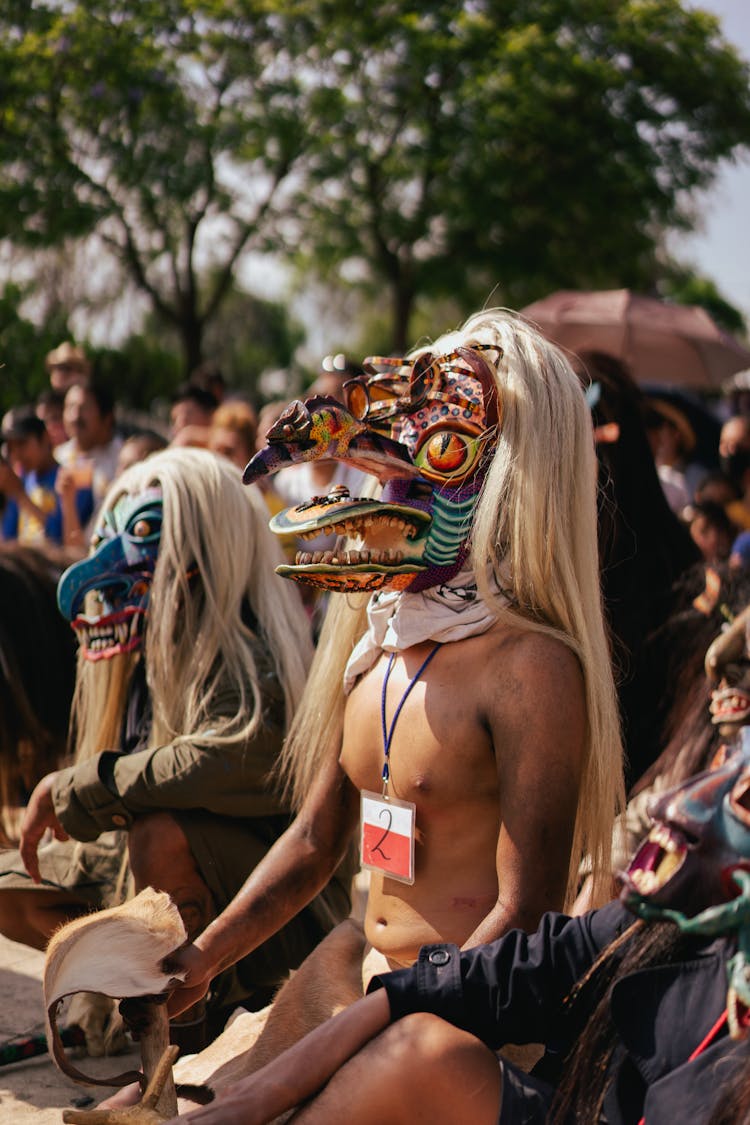 Close Up Of Two Man In Carnival Masks In The Crowd