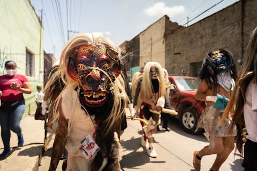 Traditional Mexican festival with dancers in colorful masks and costumes on a sunny street.